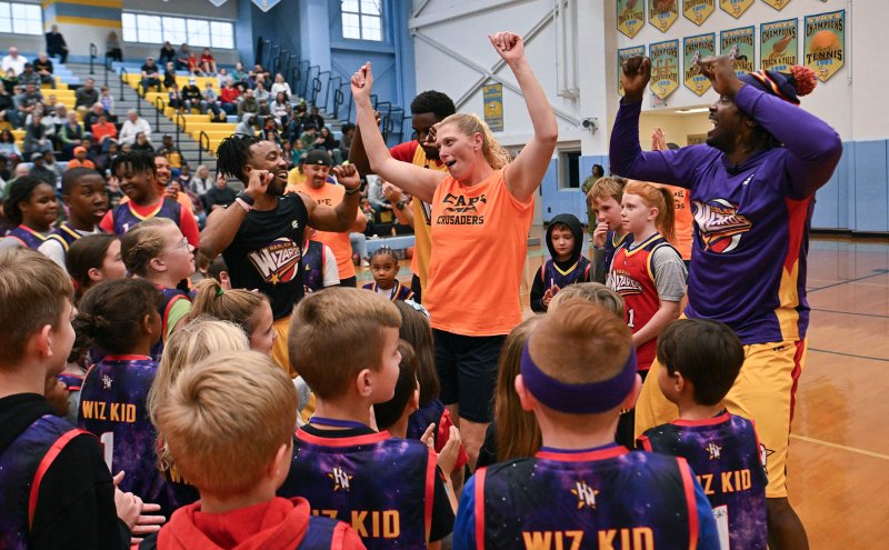 Love Creek teacher Kelly Hynes shows some dance moves with King Arthur and the Wiz Kids at the 2024 Harlem Wizards and Cape Crusaders game. DAN COOK PHOTO