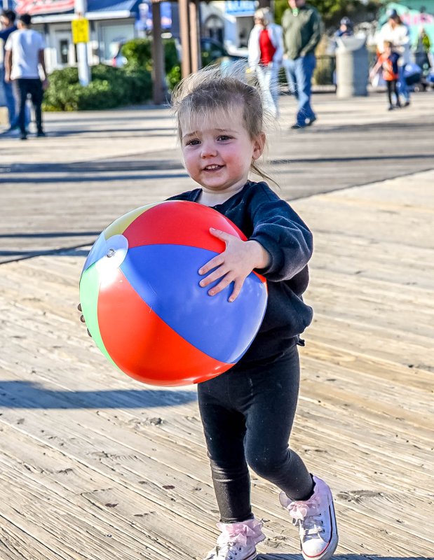 Taking a shortcut with her beach ball is Sadie Janson, 2. DAN COOK PHOTO