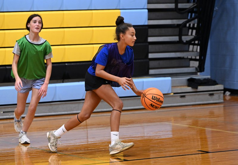 Sixth-grader Angie Everett dribbles during a ball control drill.