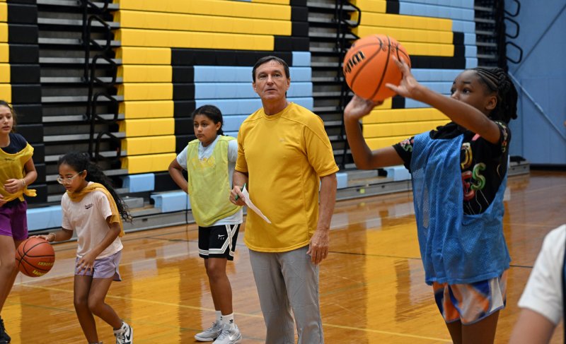 New Cape girls’ coach Ron Dukes watches Emma Gambale during a shooting drill.