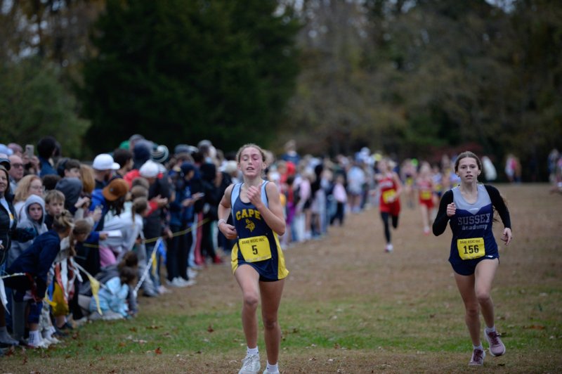 Stella Hastings of Mariner and Eva Piper of Sussex Academy race to the finish.