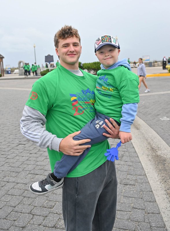 Cape grad Zane Coulbourne hoists his buddy Charlie Honeysett of the Charlie’s Angels team before the annual Buddy Walk.