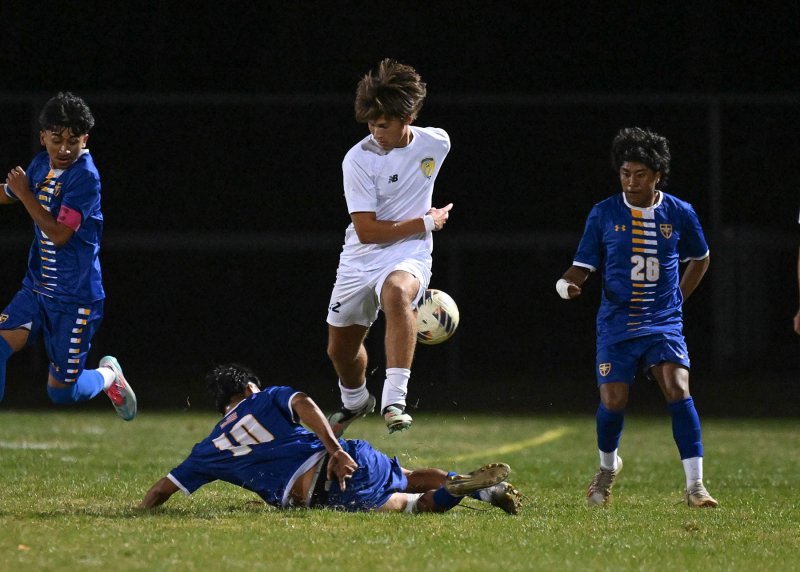 Cape’s Jackson Hess avoids a takeout by a Central defender.