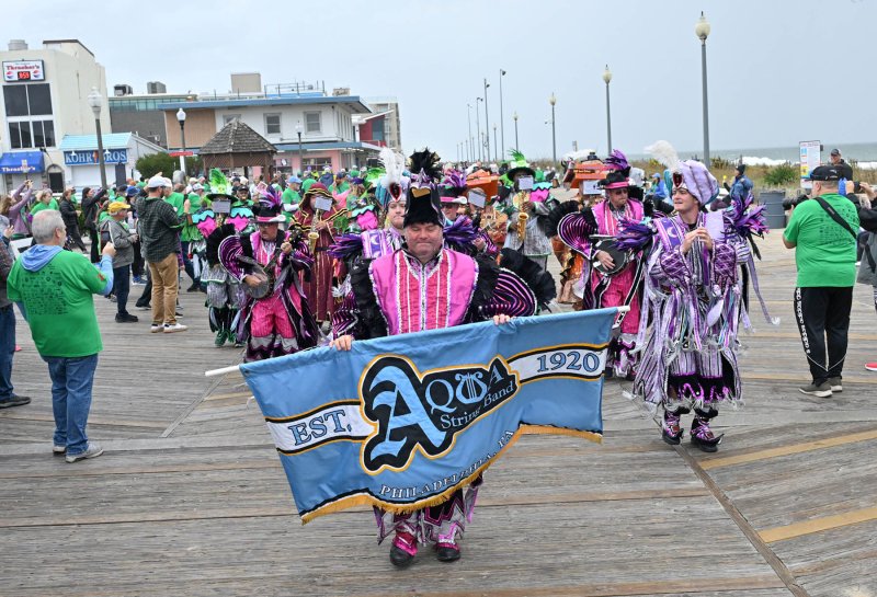 The Philadelphia Mummers Aqua String Band performs the strut up the Boardwalk during the Buddy Walk.