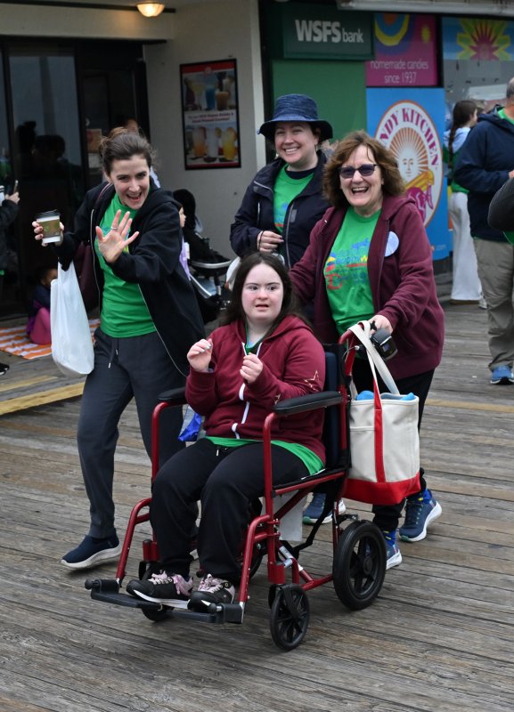 Lizzie Miley applauds the walk with her team (l-r) Lorrie-Beth Miley, Gina Boczkowski and Jean Miley.