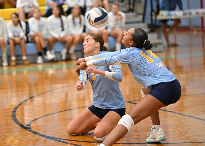 Cape’s Camilla Willis, left, and Journey McDaniel nearly collide diving for a dig.