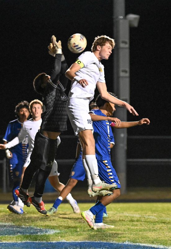 Lawson Whaley puts a header on the Central goal cage.