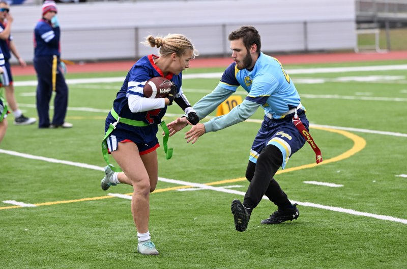 Cape’s Jaxon Benton goes for the flag of Newark Charter’s Madison Myers.