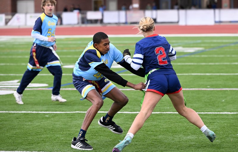 Cape’s Zane Richardson goes for the flag of Newark Charter’s Madison Myers.