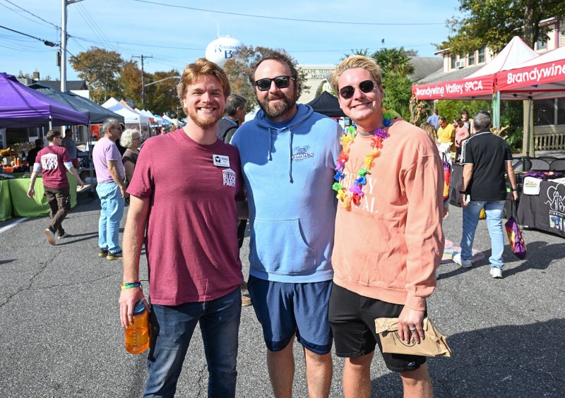 CAMP Rehoboth Communications Manager Matty Brown, left, walks the event with friends Ian and Cullen O’Connor.