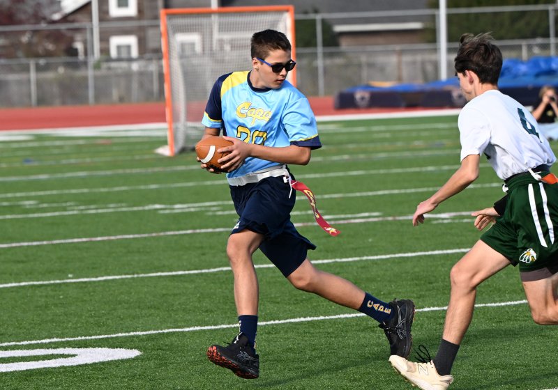 Cape’s Aiden Curran avoids the flag pull by IR’s Brayden Bennetch.