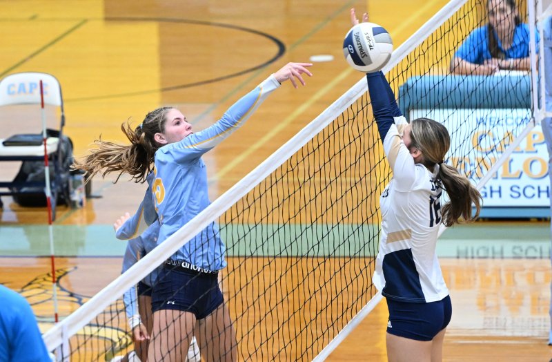 Senior Amalia	Fruchtman slams a winner past Madelyn McNicholas.