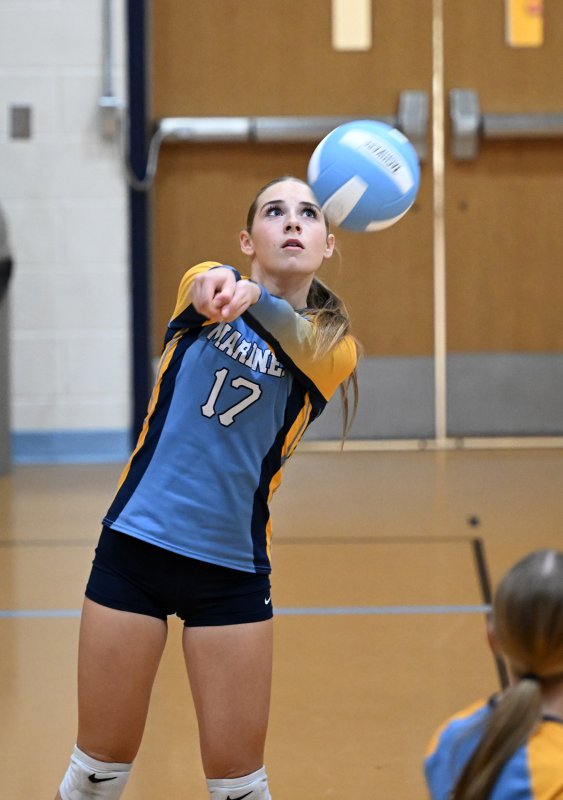 Adalynn Kaminski bumps a return for Mariner.