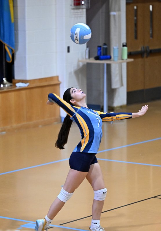 Madeline	Hill powers a serve for Mariner.