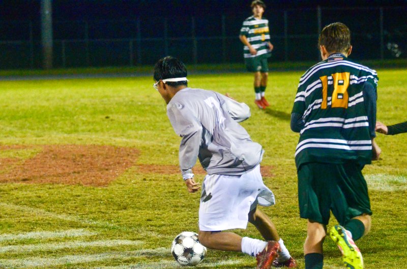 Sussex Academy junior Jose Figueroa-Morales dribbles near midfield.