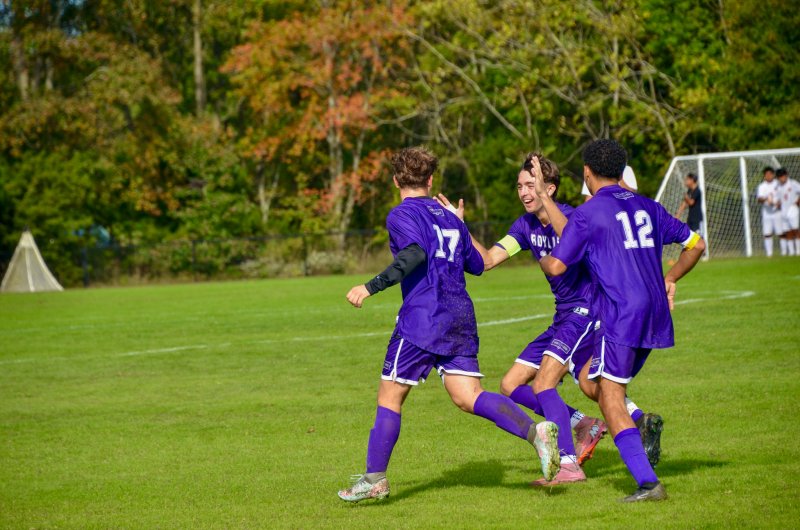 Delmarva Christian sophomore Ian Campbell, left, is congratulated by a smiling Jay Parrish and Cam Smithson after scoring the Royals' first goal. All three players scored in the Oct. 15 2-0 win over Laurel. AARON R. MUSHRUSH PHOTOS