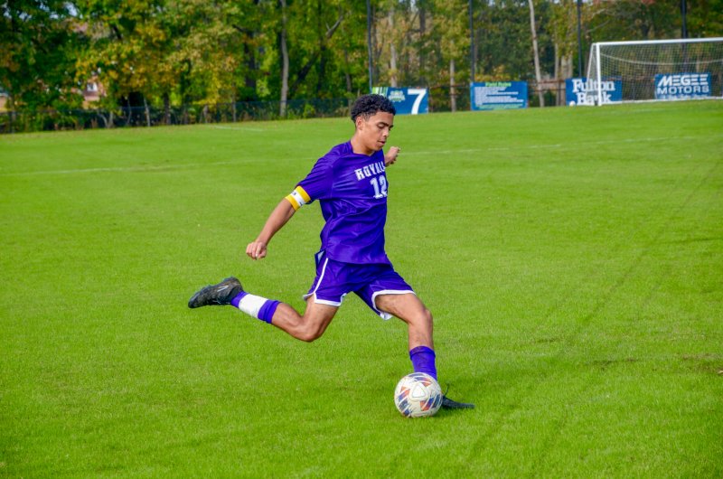 Royals captain Cam Smithson crosses the ball.