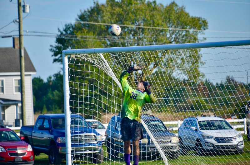 Delmarva Christian junior Isaiah McCluskey nearly gets his hand on this ball that rattled off the crossbar.