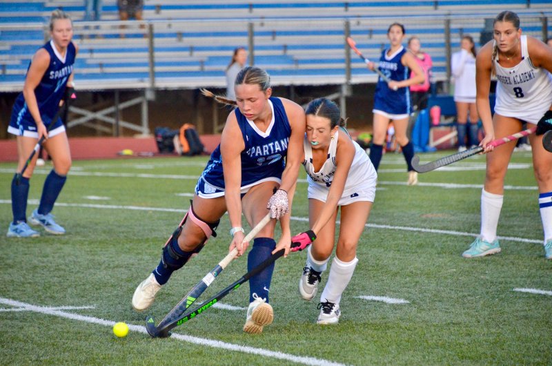 Lake Forest senior Ella Robbins spars with freshman Mady Lehman for the ball.
