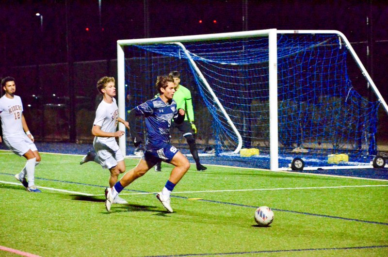 Sussex Academy senior George Sapna chases down a ball in the box.