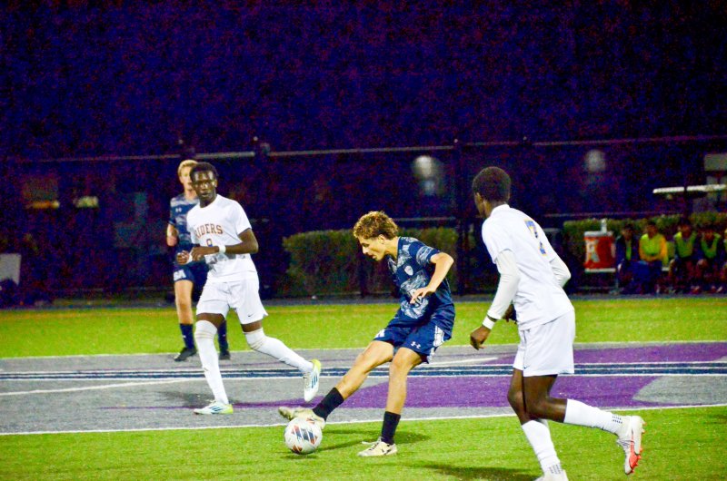 Seahawks senior Liam Stegall passes the ball at midfield.