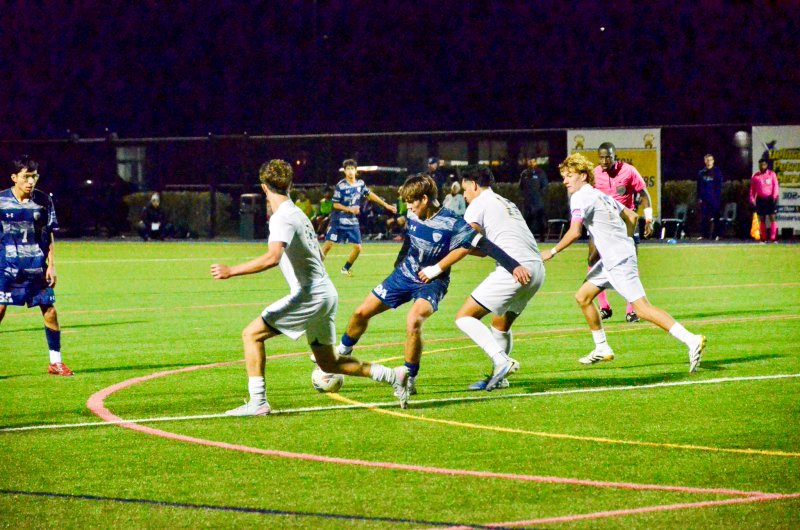 Sussex Academy senior George Sapna shields the ball from Caesar Rodney senior Axel Jackson.