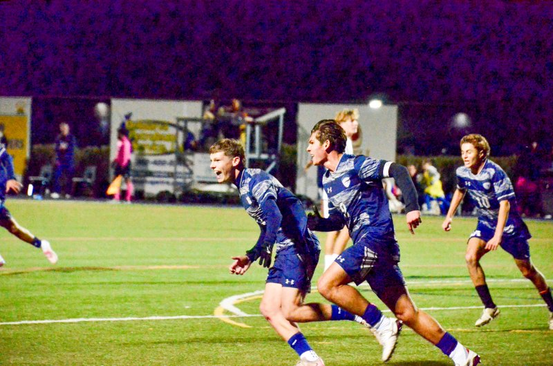 Sussex Academy seniors Chase Ballinger, left, and Liam Stegall celebrate George Sapna, center, tying the game.