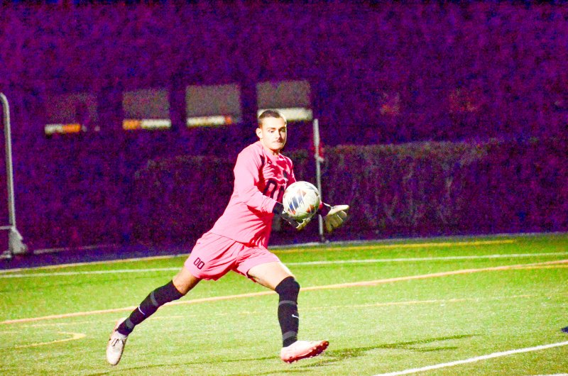 Sussex Academy senior Austin Taylor boots the ball.