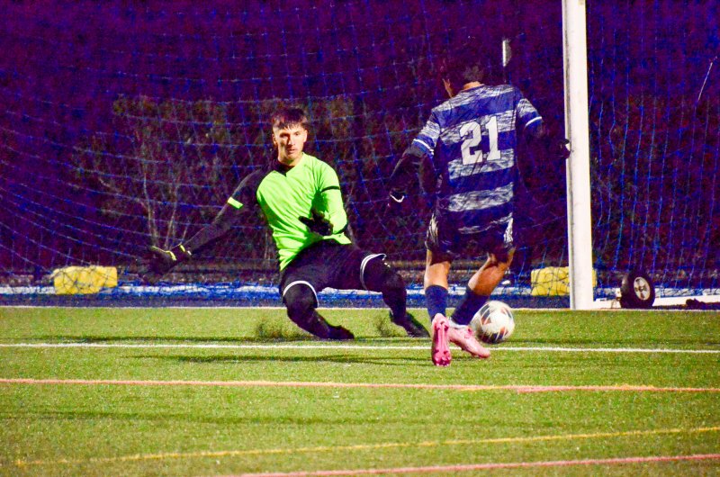 Caesar Rodney keeper Logan Simmons cuts down the angle for a save.