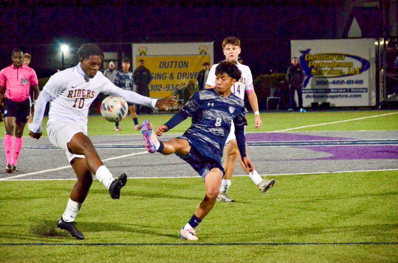 Sussex Academy senior Ruendi Ortiz-Santos battles with Edualy Simon for a bouncer.