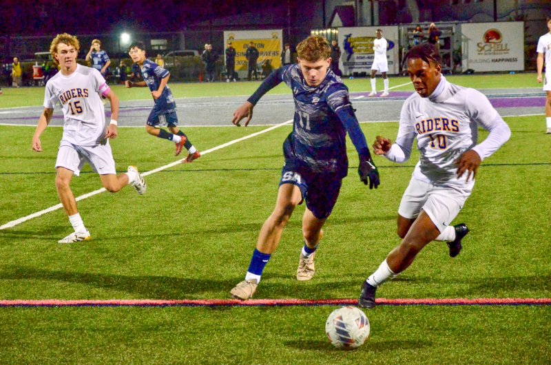 Sussex Academy senior Chase Ballinger jostles with Edualy Simon for the ball.