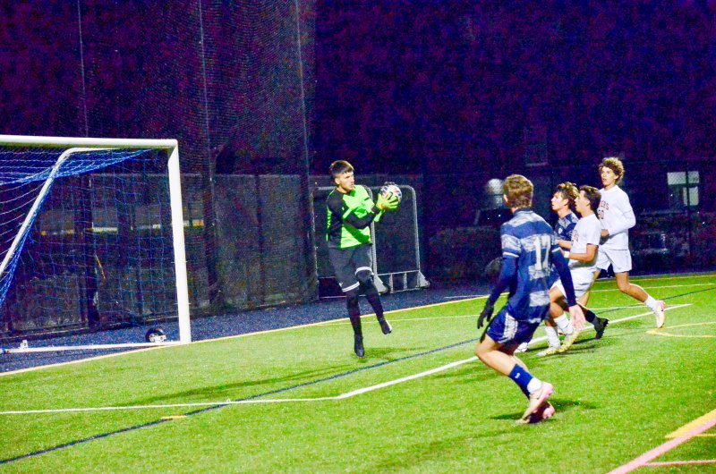 Caesar Rodney keeper Logan Simmons catches a shot for a save.
