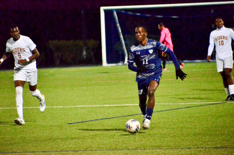 Sussex Academy senior Jesse Jean-Louis carries the ball.