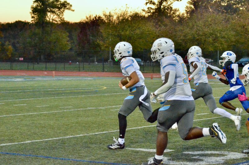 Cape quarterback Jameson Tingle leads a convoy of Tre Batson, left, and Oz Batson into the end zone to open up the scoring in the 47-28 victory over Dover Oct. 24. AARON R. MUSHRUSH PHOTOS