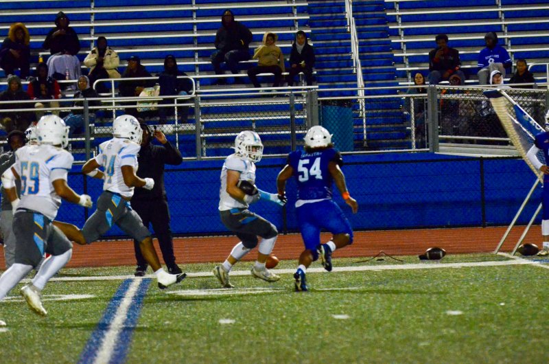 Although he was playing linebacker when he scooped and scored, Robbie Payton is the center on offense, making this score a big-man touchdown. Payton is shown here juking along the sidelines.