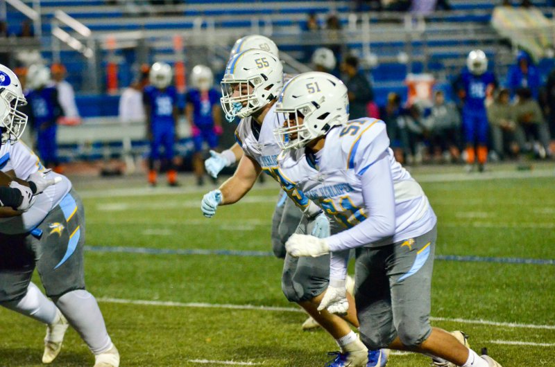 Cape junior Gawaun Curtis, right, and senior Mason Schaffer charge toward the offensive line.