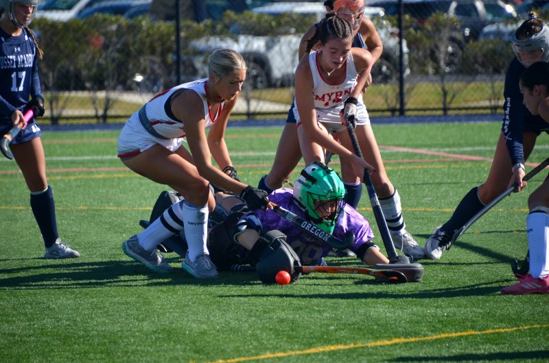 Sussex Academy senior Kacie Rawlings tries to get up with two knees in her back.