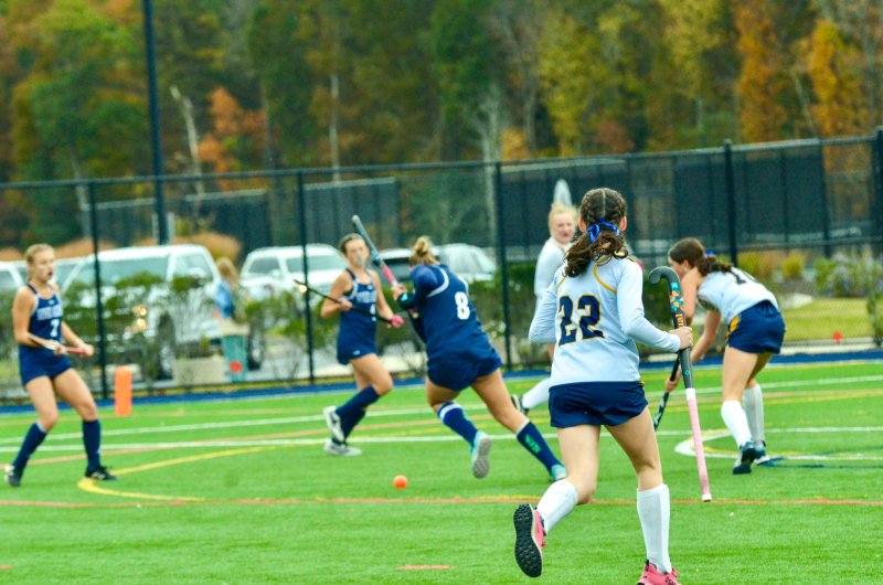 In the background, Sussex Academy senior Ryan Lowe uses her backhand to score the first goal.