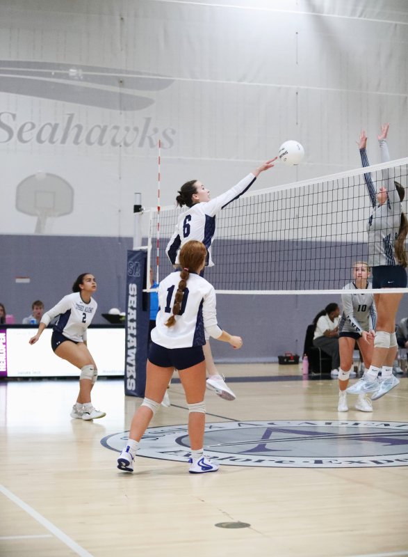 Sussex Academy junior Veronika Mussina extends her reach at the net.