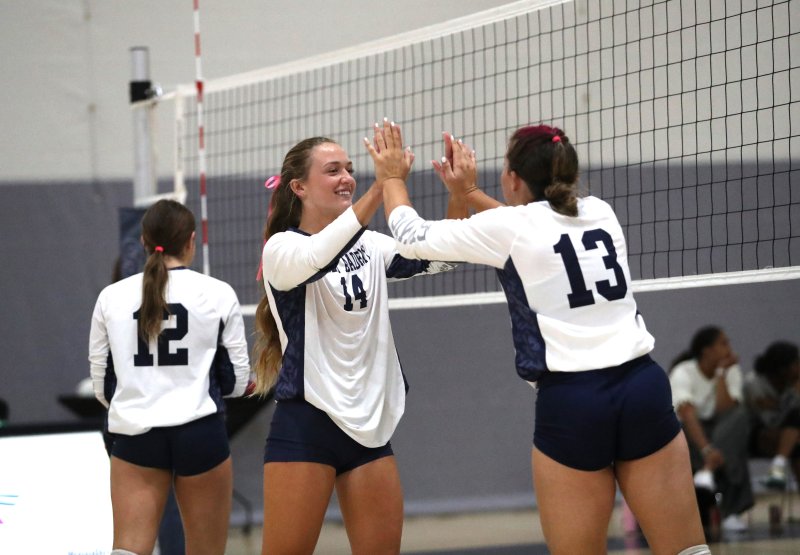 Sussex Academy senior Ellie Merrick slaps hands with junior Grayce Glover.