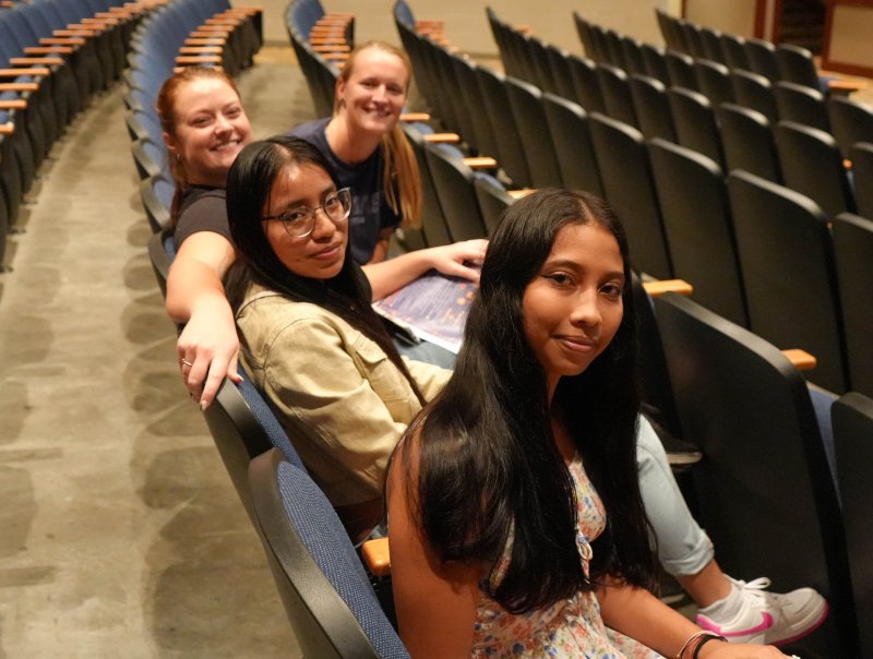 Students Naomi Jiminez, front, and Marta Lux, sitting to her right, are ready for the ceremony to begin. They’re joined by Olivia Swain and Taylor Quillen.