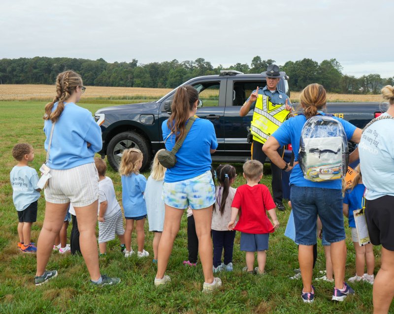 Delaware State Police Sr. Cpl. Patrick Jackson shows some of the police equipment to a group of Little Vikings students and teachers.