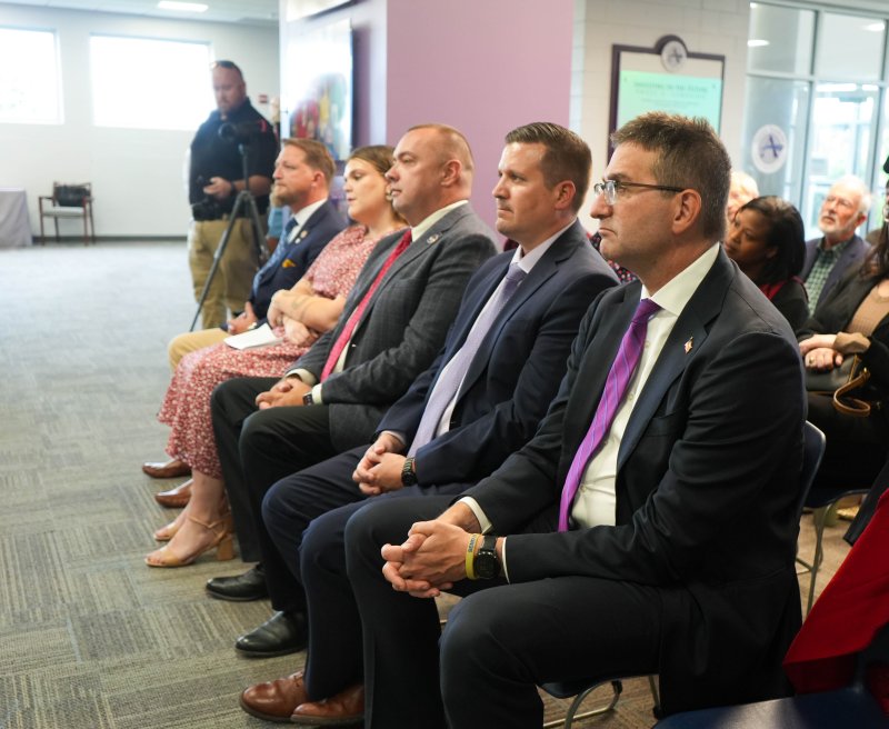 Legislators and local dignitaries listen to Sara Poore, executive director of the Delaware Anti-Trafficking Action Council, give a speech. Shown sitting are (l-r) South Carolina Rep. Brandon Guffey; Hannah Cesner, director of strategy and advancement at Zoe Ministries of Delaware; Sen. Brian Pettyjohn, R-Georgetown, Senate minority whip; Sussex Academy Head of School Kyle Bentley; and Gov. Matt Meyer.