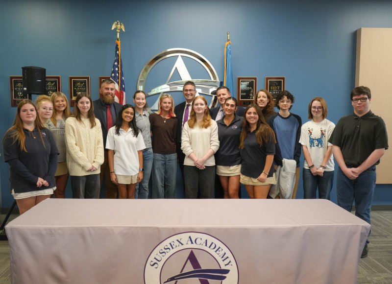 A number of Sussex Academy students attend the signing. Shown are (l-r) Finna Graves, Natalia Gatti, Emma Feaguns, Caitlin Redick, board President Ed Hale, Priya Haldar, Veronica Musina, June Hale, Gov. Matt Meyer, Shannon Scudder, Head of School Kyle Bentley, Kimi Langroudi, Bella Crisci, Delaware Charter Schools Network Executive Director Kendall Massett, Marissa Davis, Juno Turner and Wesley Knudsen.