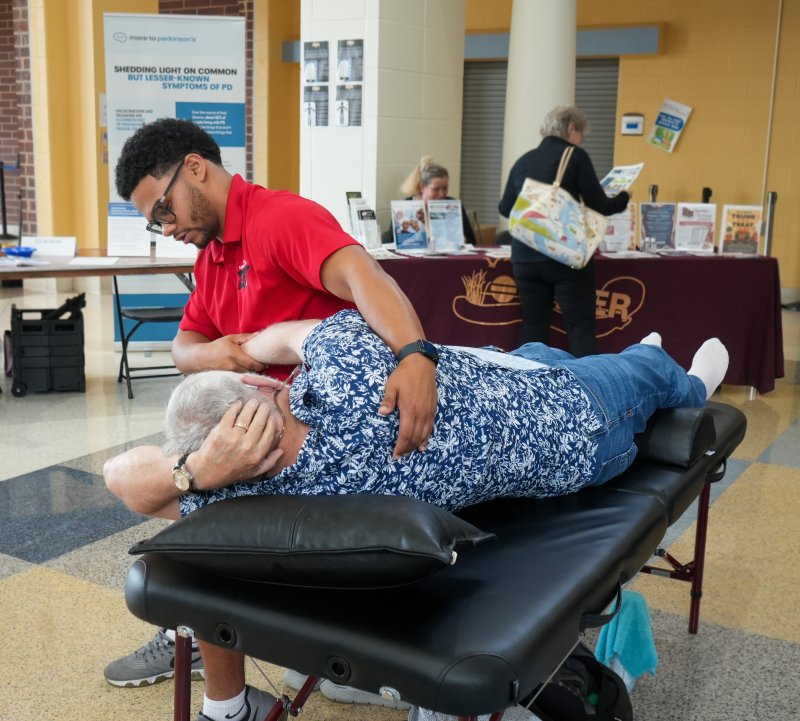 Jordan Gambrell, a stretch therapist at Shore Wellness, provides a free 10-minute stretch session to Ernie Gelb during the Parkinson’s Education & Support Group of Sussex County’s annual Living Well with Parkinson’s Expo, held at Cape High on Oct. 11. ELLEN MCINTYRE PHOTOS