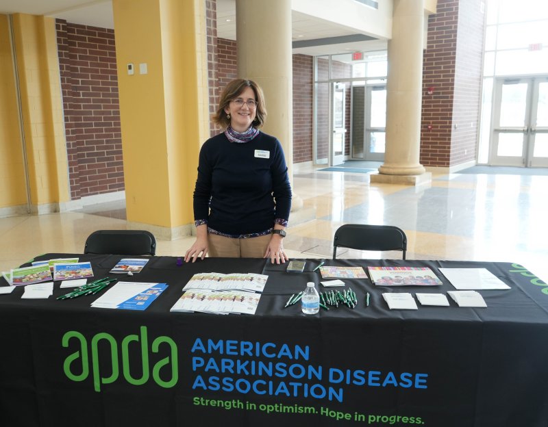 Anne Hubbard, chief public policy officer at the American Parkinson Disease Association, is stocked with informational resources for attendees.