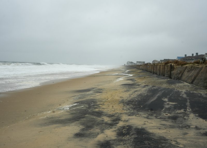 The waves hammering the shore cause beach erosion in Dewey. ELLEN MCINTYRE PHOTO