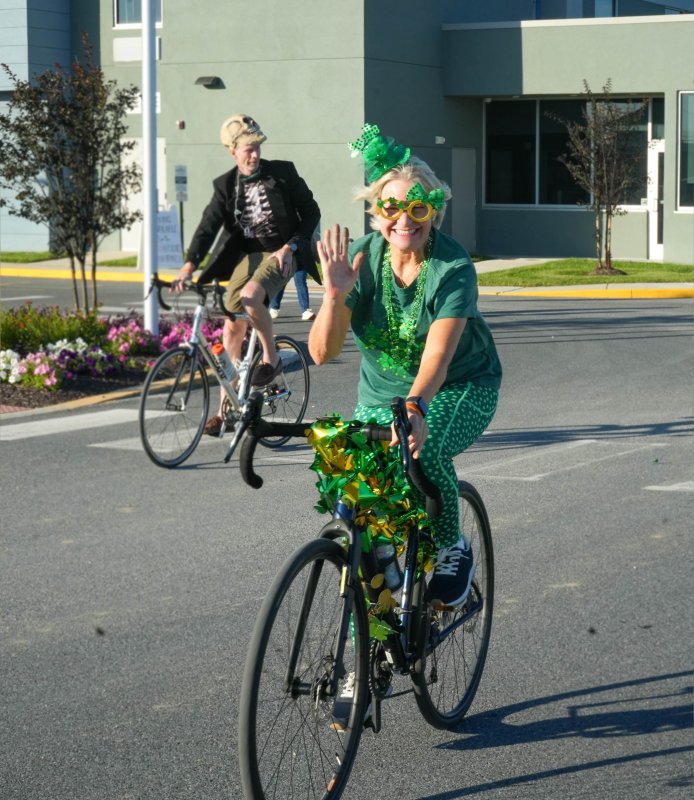 Susannah Baden and her bike are all decked out for the Dilly Dally Cruiser Rally. Behind her is Todd Conway.