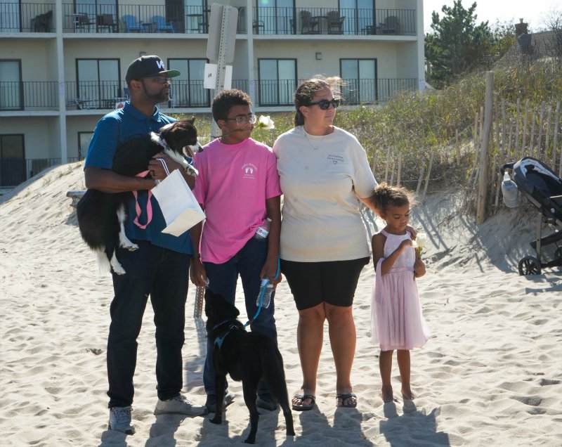 The Collins family listens as one of the Beebe nurses reads a poem during the memorial service. Shown are (l-r) John, Malachi, Ashley and Topanga.