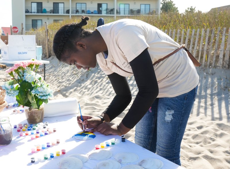 Za’Niyah Chandler paints a seashell after the memorial service. She attended the event with her aunt, Carolyn Spence, who works in Beebe’s Labor & Delivery unit.
